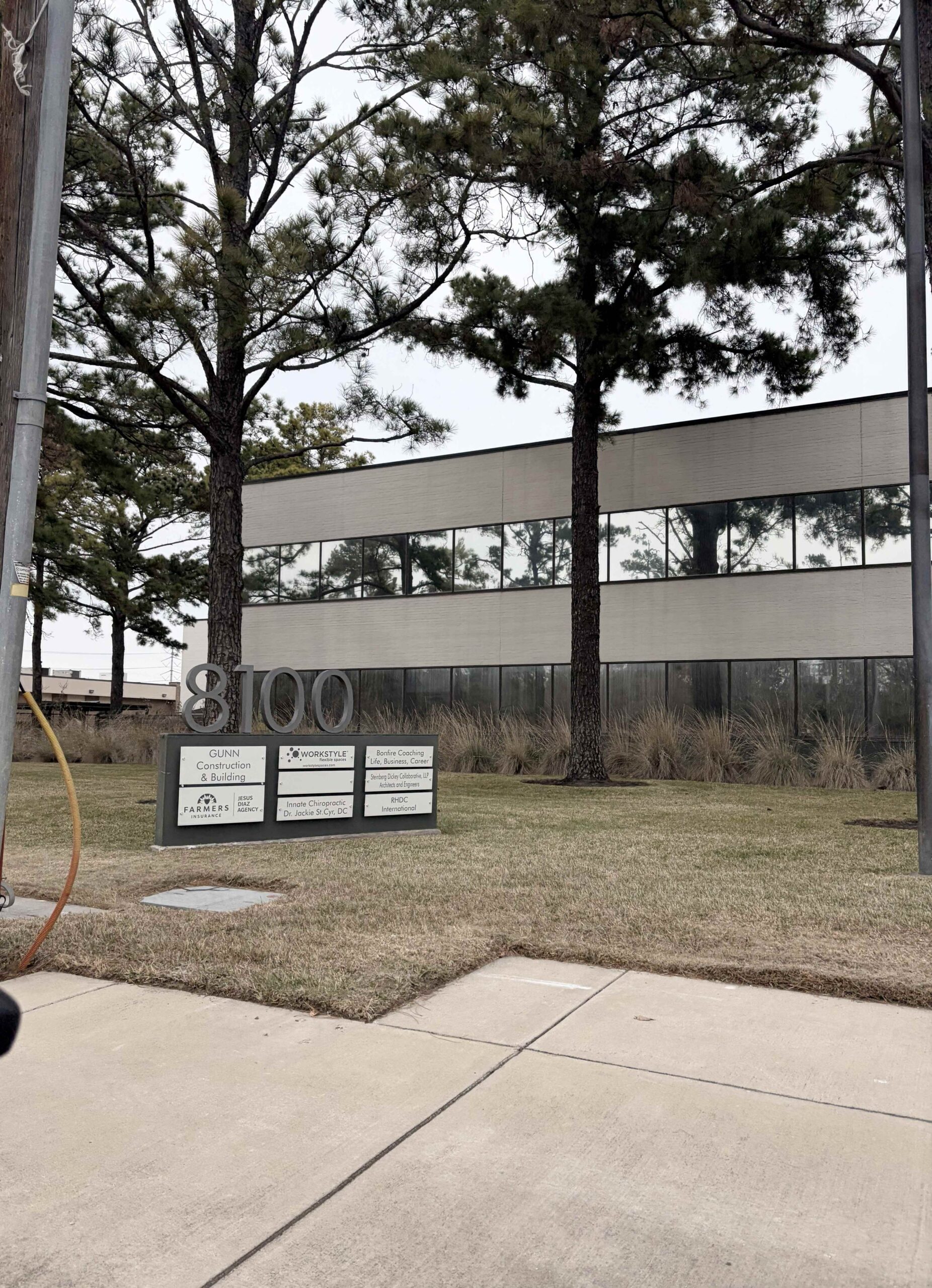 Exterior sign for the office building where KVM Law Firm is located in Houston