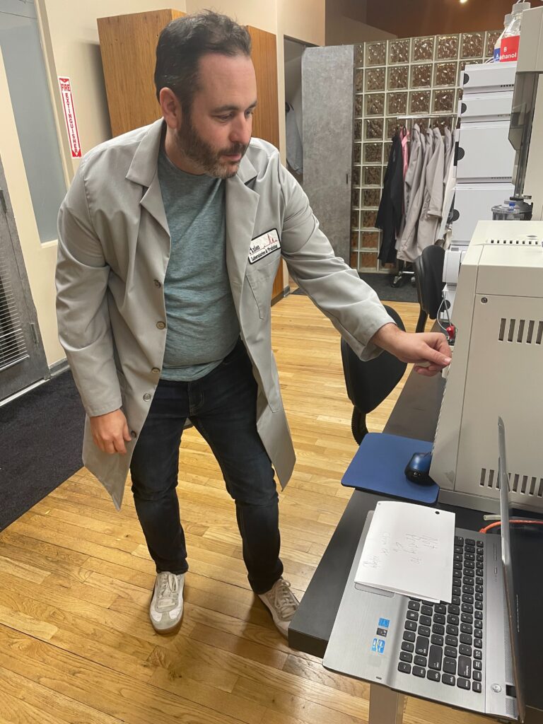 Houston DWI lawyer Kenneth Maung operating gas chromatography equipment during forensic science training